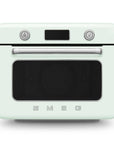 Front view of pastel green Smeg retro line countertop air fry oven on a white background