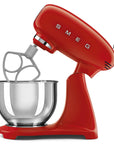 Red Smeg stand mixer slanted open with mixing bowl on a white background