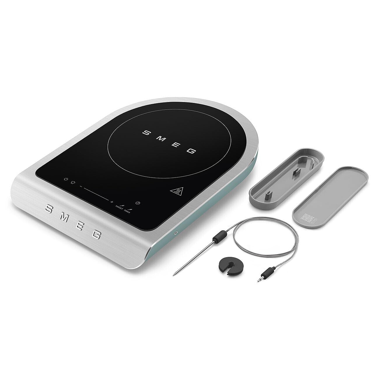 Portable induction cooktop with accessories on a white background, featuring the SMEG brand.