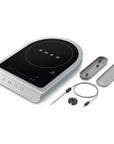 Portable induction cooktop with accessories on a white background, featuring the SMEG brand.