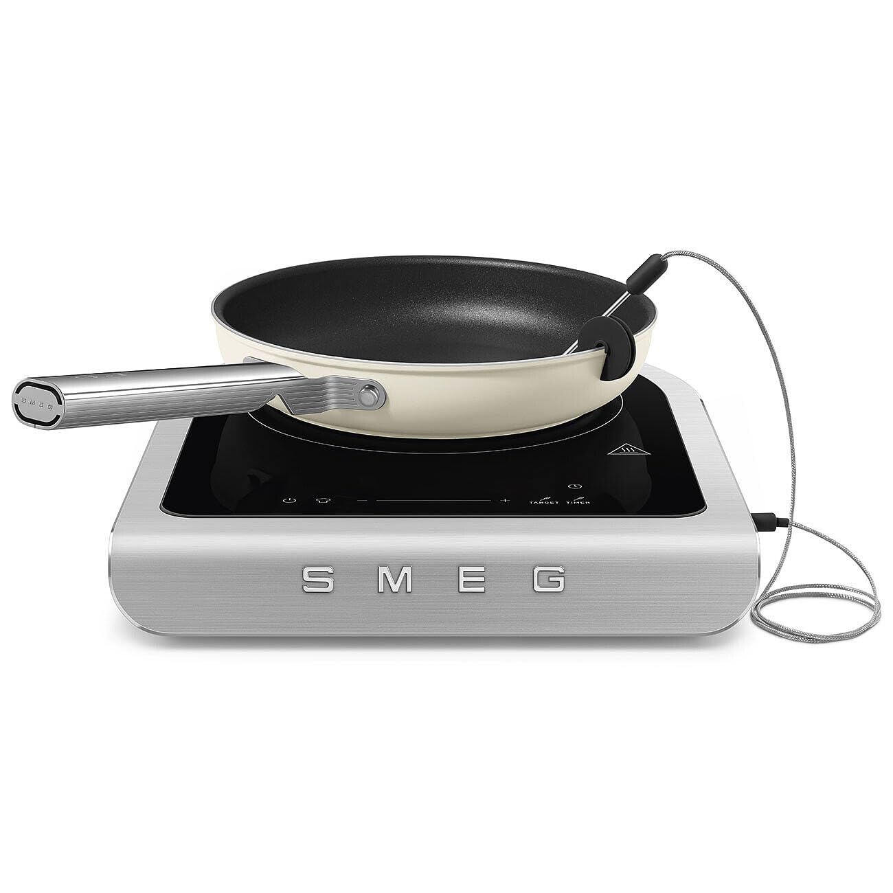 Portable induction cooktop with a frying pan on a white background, featuring the Smeg brand.