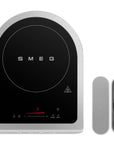 Smeg induction cooktop with temperature probe on a white background