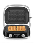 Black Smeg grill with silver accents with made waffles on a white background