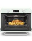 Pastel green Smeg retro line countertop air fry oven with door open with food on a clear container on a white background