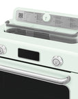 Pastel green Smeg retro line countertop air fry oven with digital panel with 2 switch knobs and lid open on a white background