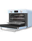Pastel blue Smeg retro line countertop air fry oven with door open with baking sheets on a white background