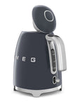 Navy blue Smeg 50s retro line electric kettle with lid open displayed on a white background