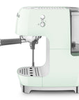 Side view of pastel green espresso machine with Smeg logo on a white background