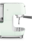 Side view of pastel green espresso machine with Smeg logo on a white background
