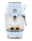 Pastel blue SMEG espresso machine with two cups of coffee on a white background