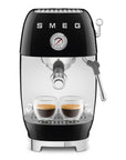 Black Smeg espresso machine with two cups of coffee on a white background