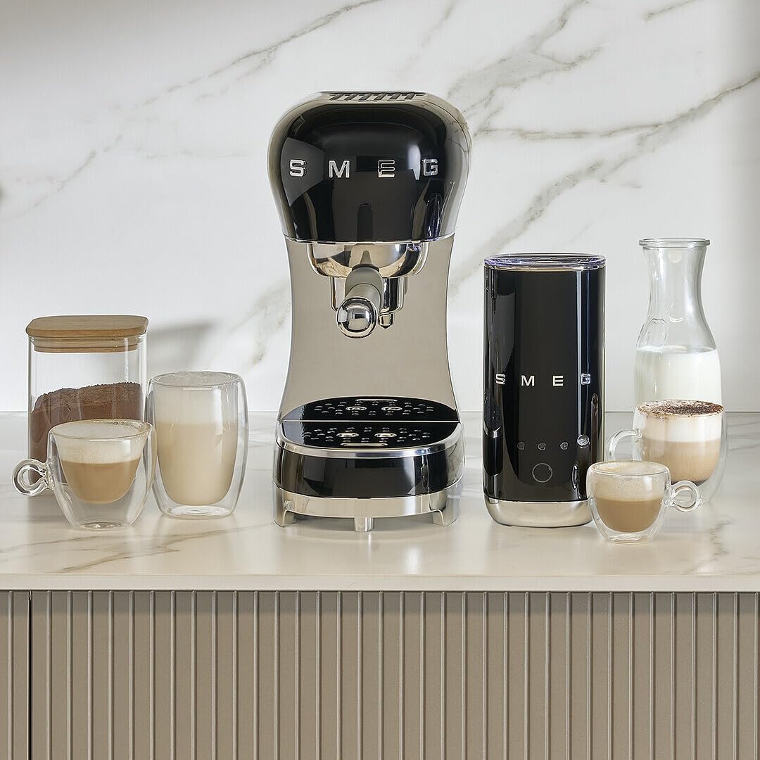 Black Smeg coffee machine on a kitchen counter with various coffee items.