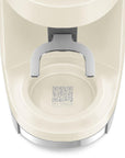 Close-up of a cream-colored My Smeg Assistant coffee grinder base, showing the metallic silver handle and the My Smeg Assistant logo printed on the inner cup.