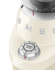 Close-up of a vintage-style coffee grinder with a prominent 'Smeg' brand logo with dial