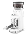 White coffee grinder with coffee bean filled hopper on a white background