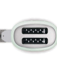 Top view of two-slot toaster with a light green casing with a drawer open on a white background