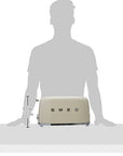 Cream-colored toaster with Smeg logo shown next to a silhouette of a person for scale on a white background.