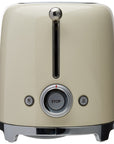 Side view of Smeg cream toaster with metallic accents and control dial on a white background