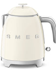 Front view of Smeg cream-colored kettle with metallic accents on a white background