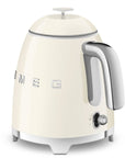 Smeg cream-colored kettle with metallic accents on a white background