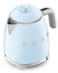 Light blue Smeg kettle with silver accents on a white background