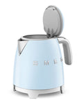 Light blue Smeg kettle with silver accents and lid open on a white background