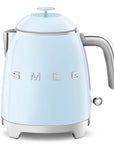 Front view of light blue kettle with SMEG logo on a white background
