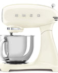 Cream-colored Smeg stand mixer with a silver bowl on a white background