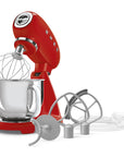 Red stand mixer with attachments on a white background