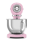 Front view of pink stand mixer with a mixing bowl on a white background