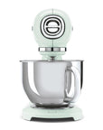 Front view of light green stand mixer with a mixing bowl on a white background