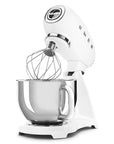 White stand mixer with whisk attachment on a white background