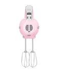 Side view of Smeg pink hand mixer with silver accents on a white background