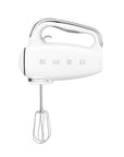 Front view of white hand mixer with whisk attachment on a white background, featuring the Smeg brand.