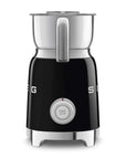 Side view of black Smeg milk frother with silver top and control dial displayed on a white background