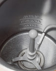 Close-up of the inside of a milk frother with 'Milk Foam Min' text on the side.