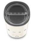 Top view of cream SMEG milk frother with lid displayed on a white background