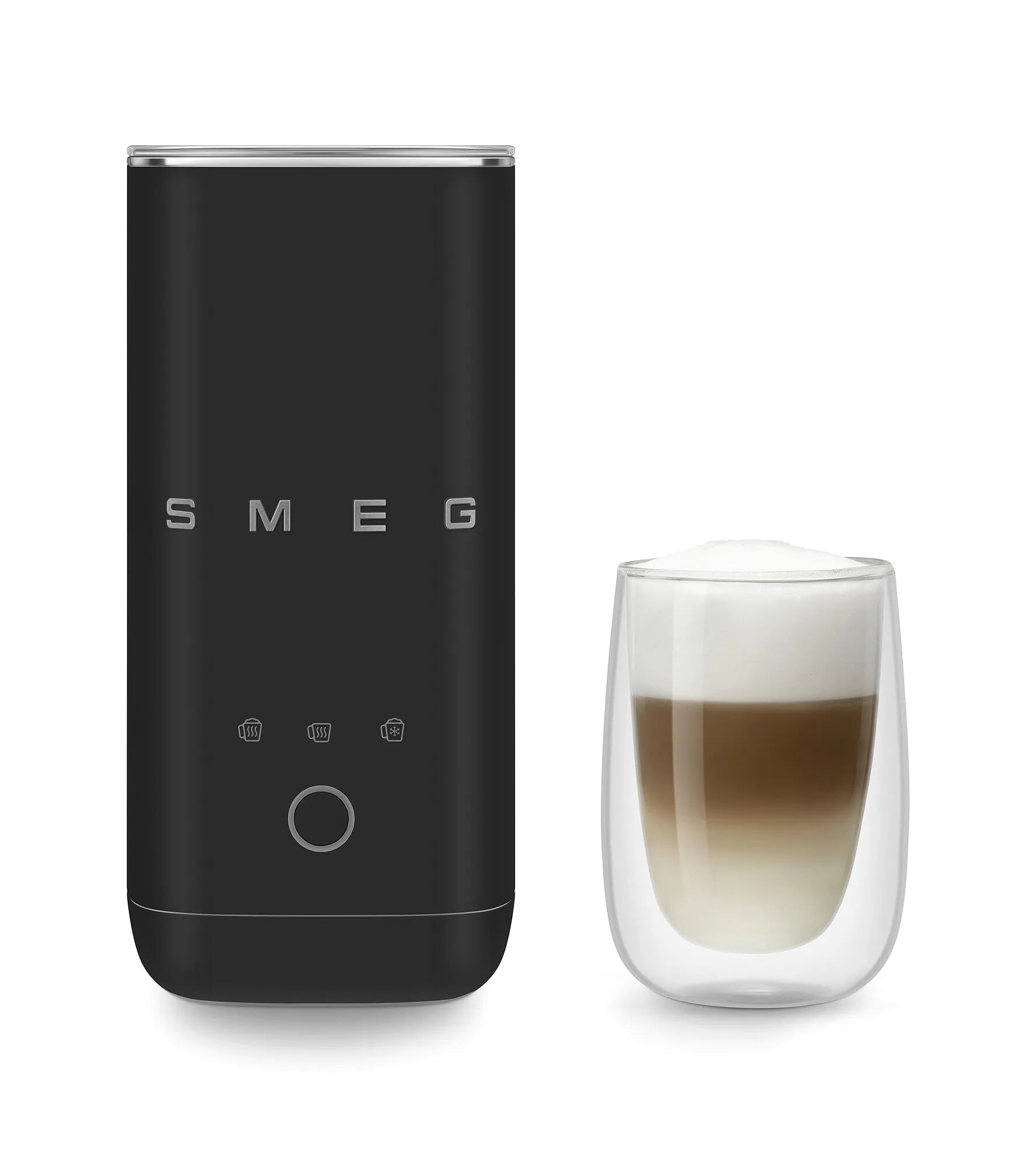A black SMEG milk frother shown next to a double-walled glass cup filled with layered latte art, on a clean white background.