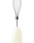 Cream kitchen whisk on a white background