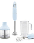 Pastel blue Smeg handheld immersion blender with attachments displayed on a white background