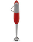 Back view of red Smeg hand blender with attachments displayed on a white background