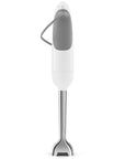 Back view of white Smeg handheld immersion blender displayed on a white background