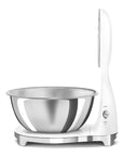 Side view of white Smeg digital scale with a silver bowl and a switch displayed on a white background