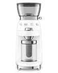 White coffee grinder with glass container on a white background