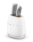 Knife set in a white magnetic knife holder with 'SMEG' branding on a white background