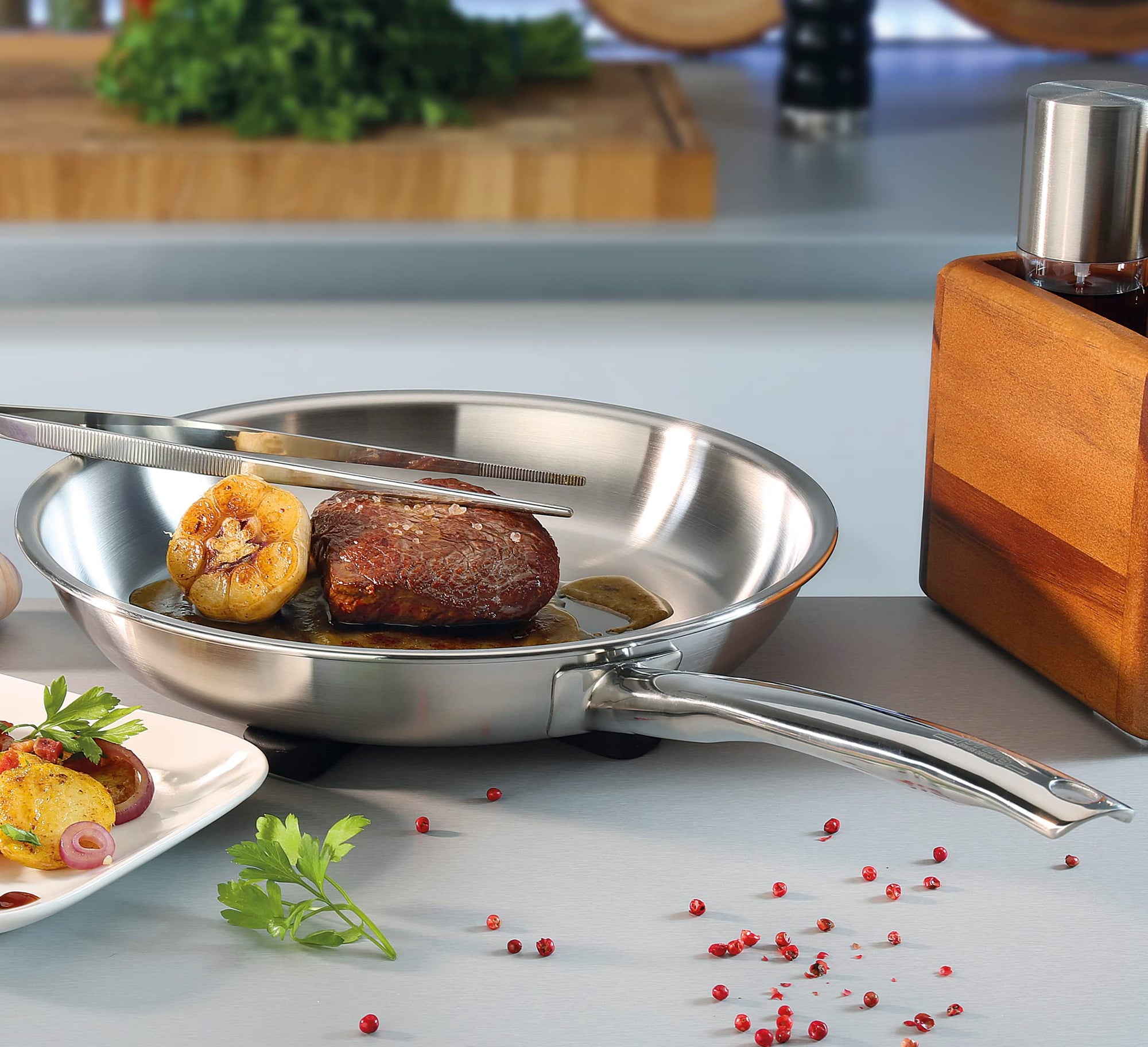 Stainless steel frying pan with food on a kitchen counter