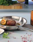 Stainless steel frying pan with food on a kitchen counter