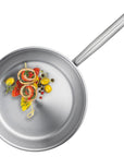 Stainless steel frying pan with food on a white background