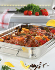 Stainless steel roasting pan with roasted vegetables on a kitchen counter