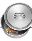 Stainless steel casserole with lid with food inside on a white background